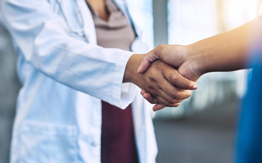 closeup of doctor shaking hands with someone