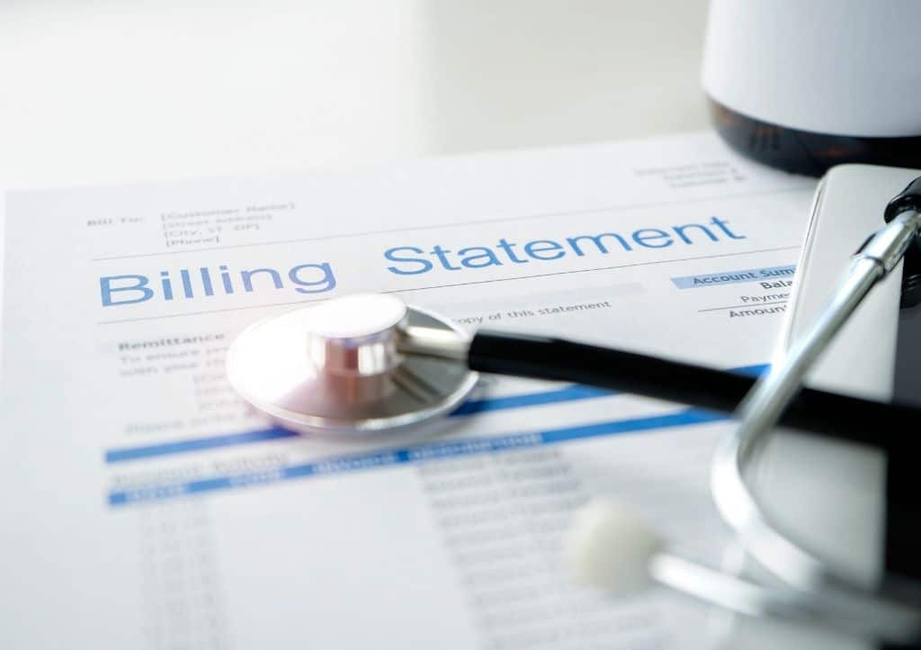Billing statement and stethoscope representing financial due diligence in a practice sale.