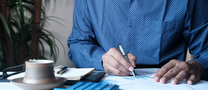 Veterinary practice owner reviewing documents and financial plans during a sale preparation meeting.
