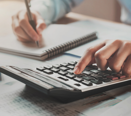 Veterinary practice owner calculating EBITDA on financial documents